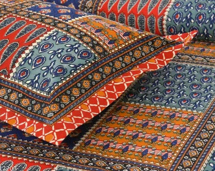 Colorful patterned fabric with intricate designs in red, blue, and orange.