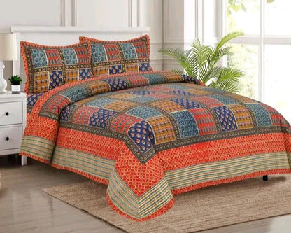 Colorful patchwork bedspread set on a bed in a bright room with a plant.
